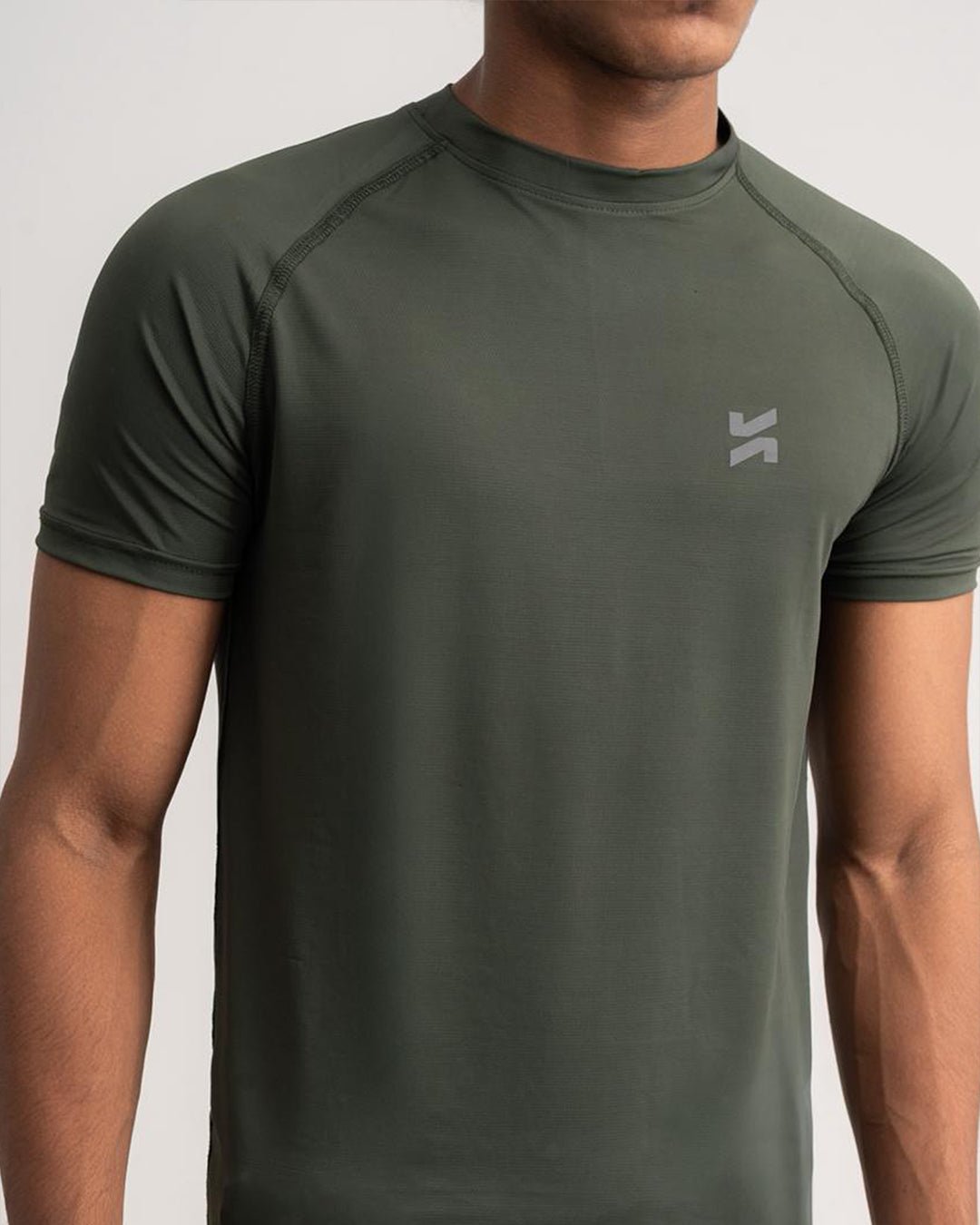Close-up of lightweight raglan T-shirt for men in olive green by KYRIX