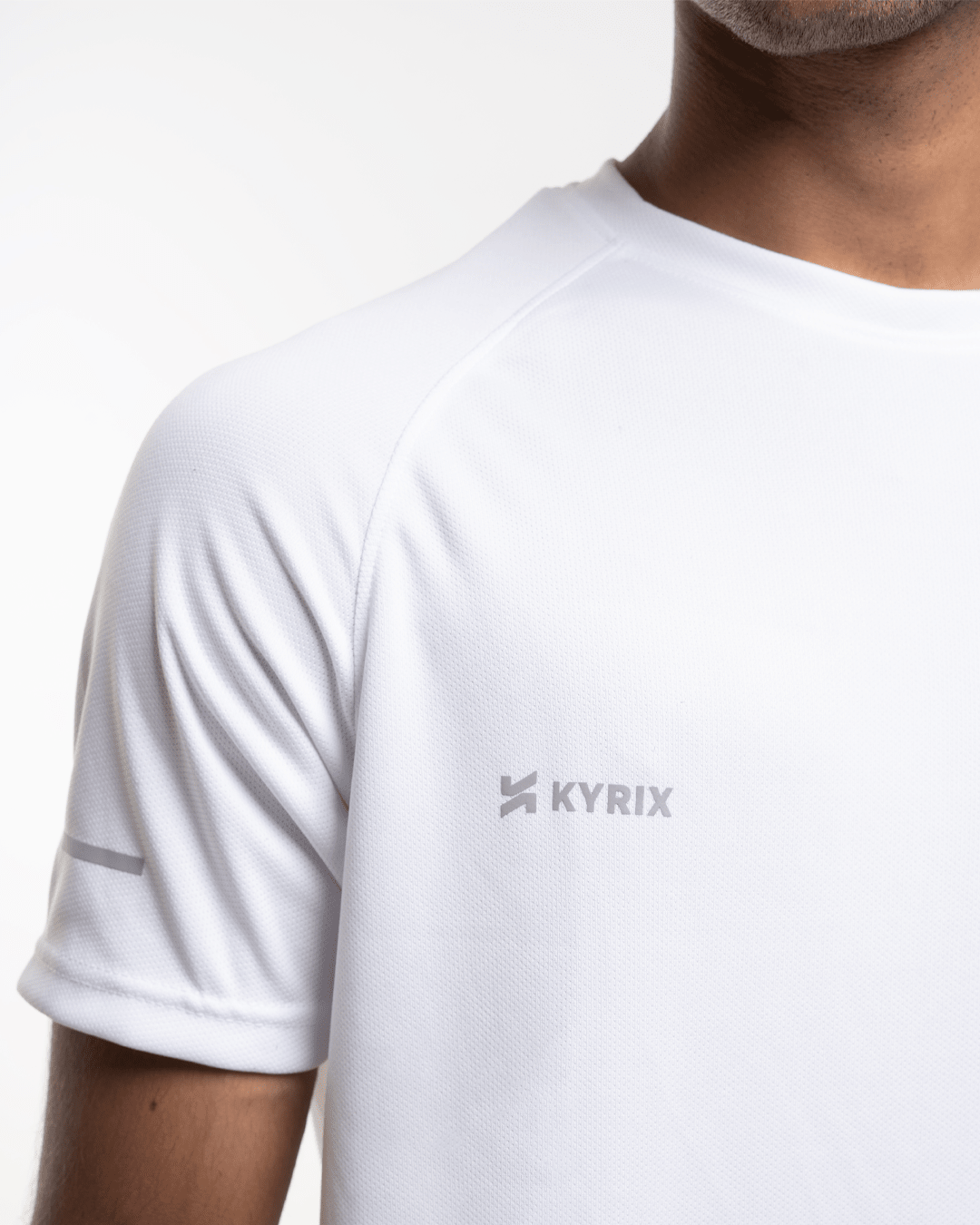 Close-up of core performance raglan T-shirt for men in white by KYRIX